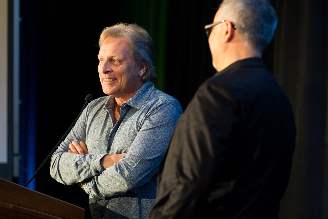Photo of two men talking on stage at GOAL: The Responsible Seafood Conference 2022